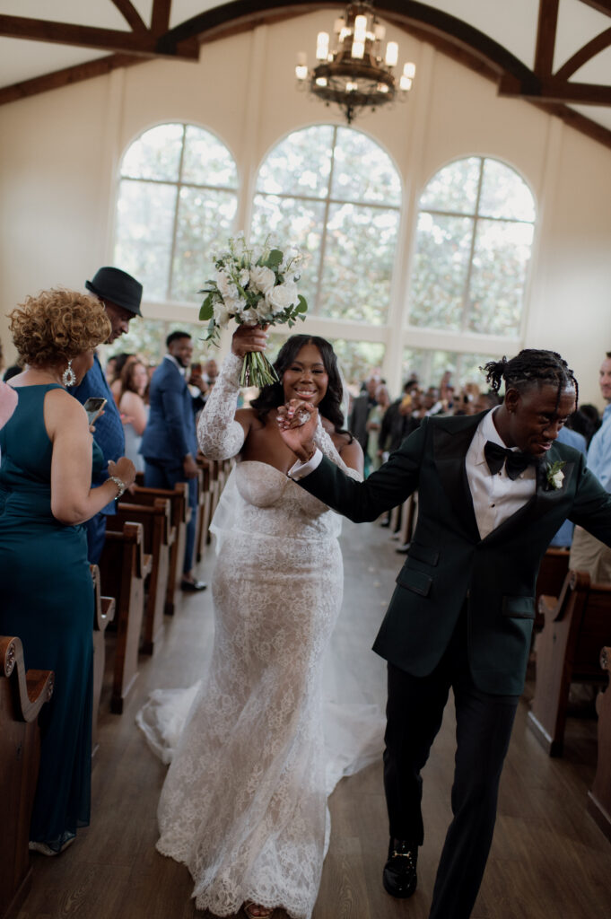 bride and groom walking down the aisle after getting married!
