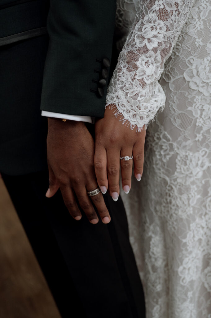 photo of bride and groom wearing their wedding rings