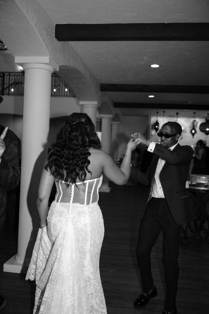 groom leading his bride to the wedding reception