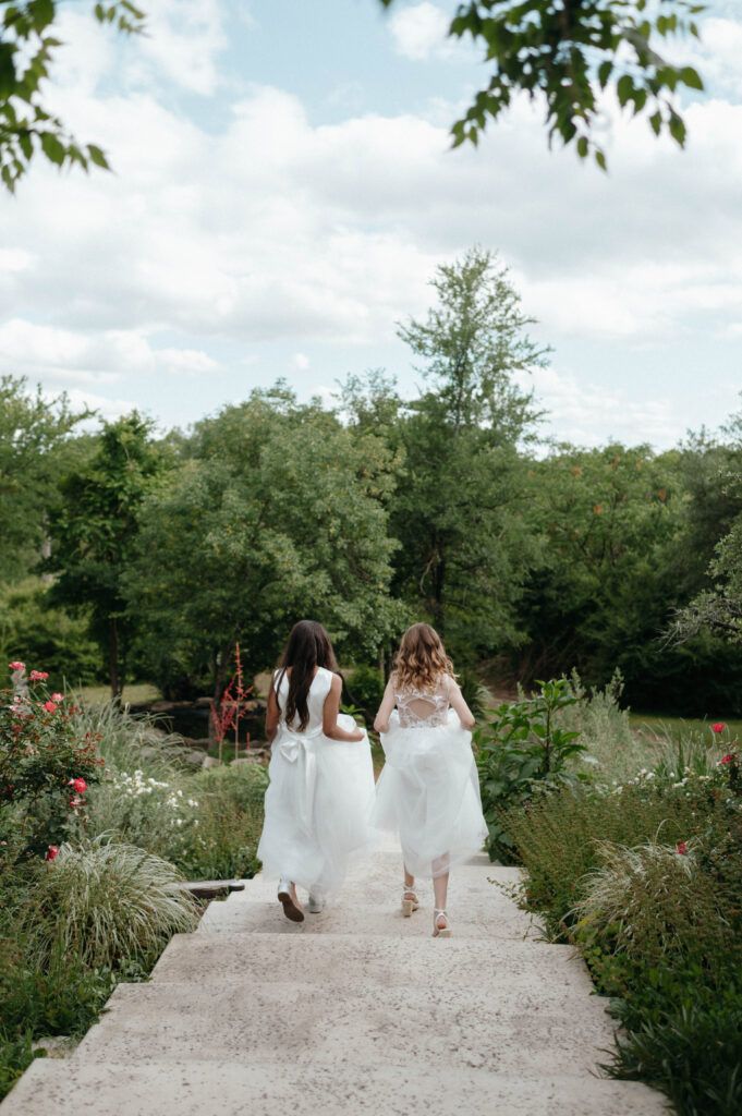 flower girls running to the garden at Hidden Gardens Venue