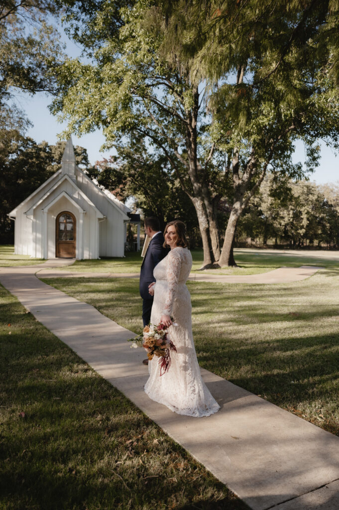bride and groom walking to the chapel at The Emerson, a Dallas Wedding Venue