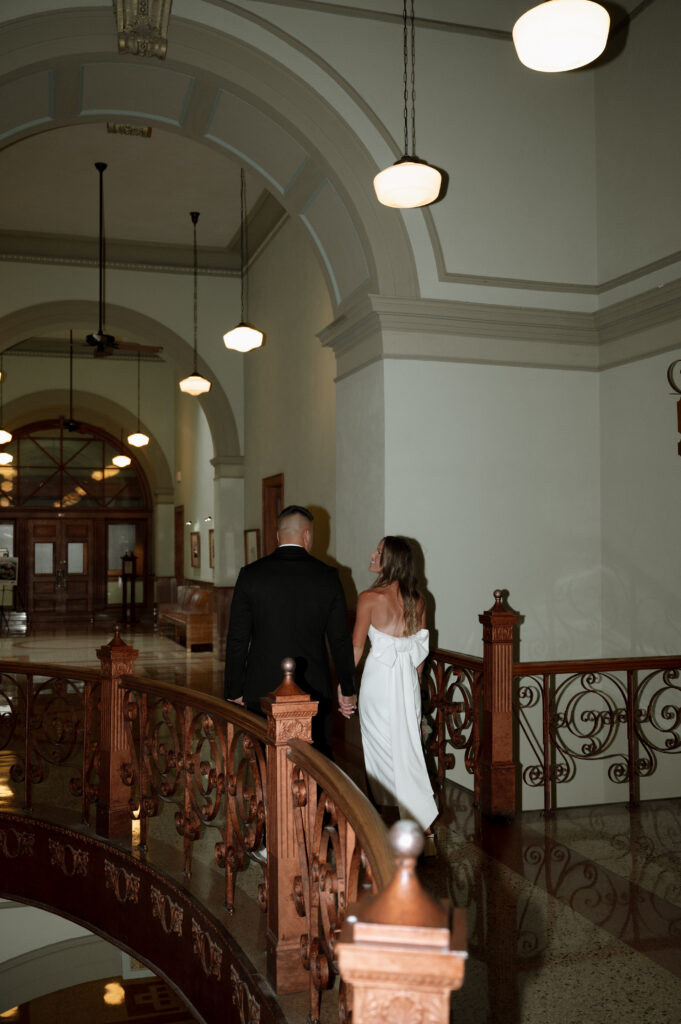 bride and groom walking inside the Tarrant county Courthouse
