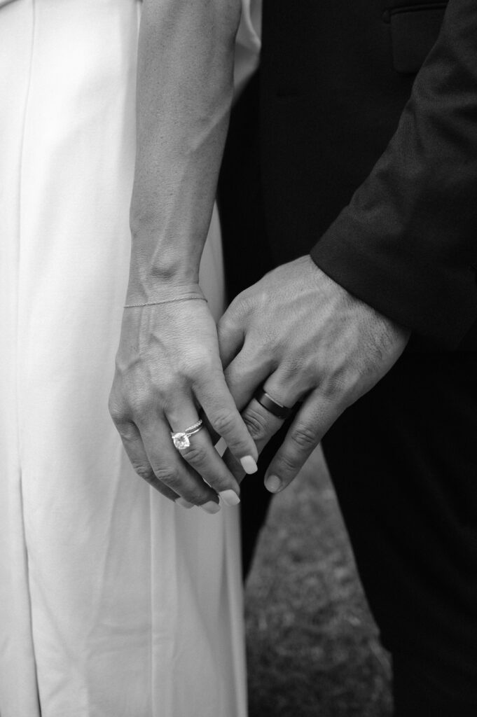 closeup photo of bride of groom hands with wedding rings