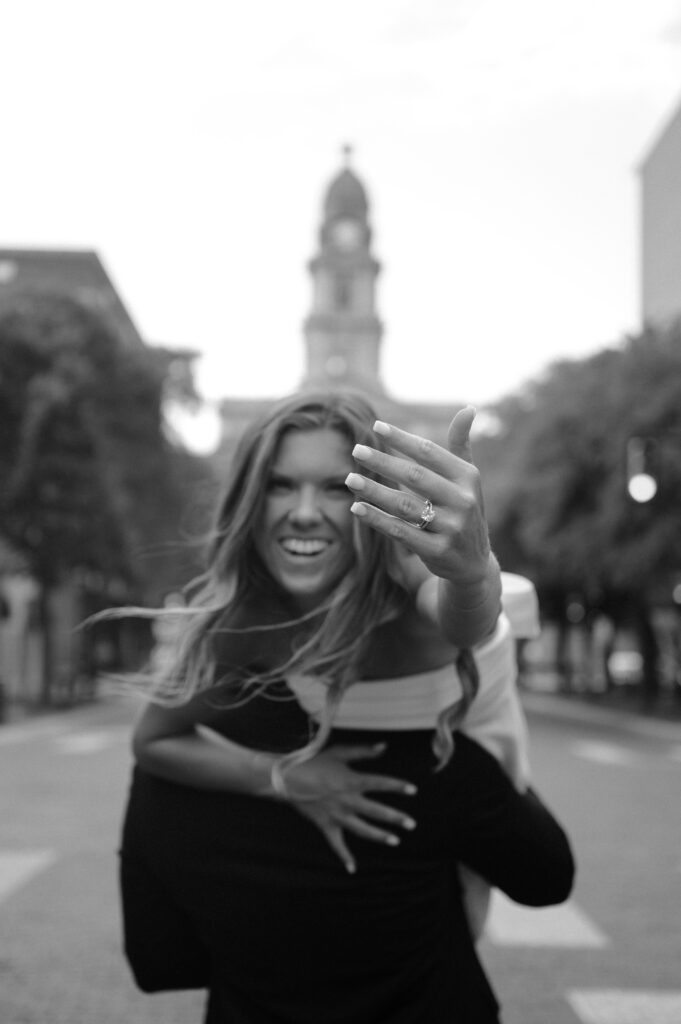 photo of bride showing off her ring in Sundance Square taken by Fort Worth Wedding Photographer