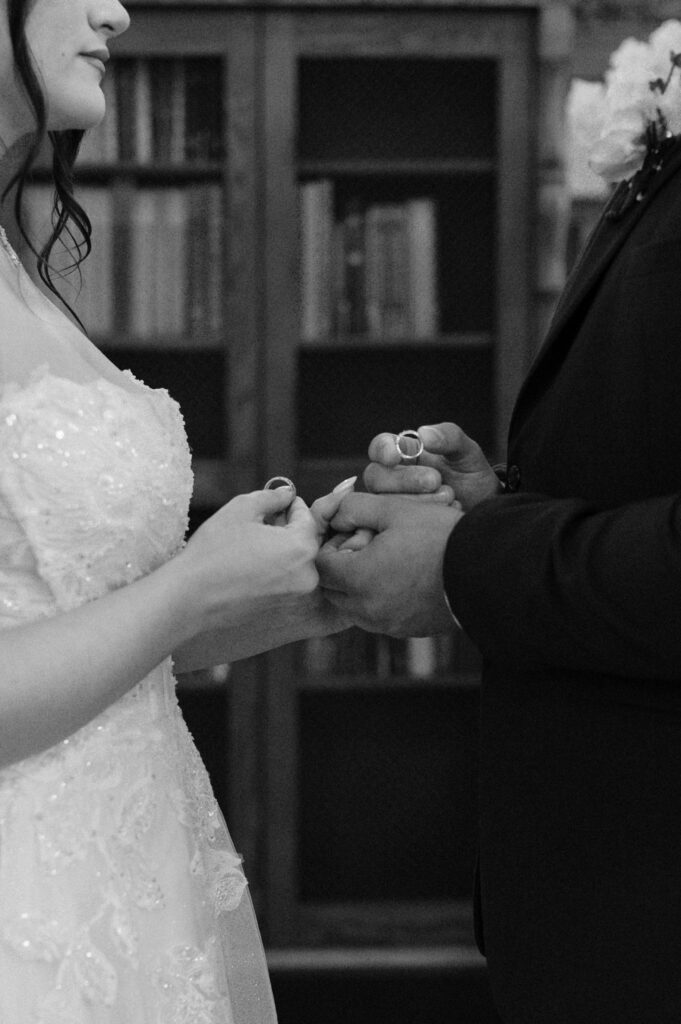 photo of bride & groom exchanging rings taken by Texas Wedding Photographer