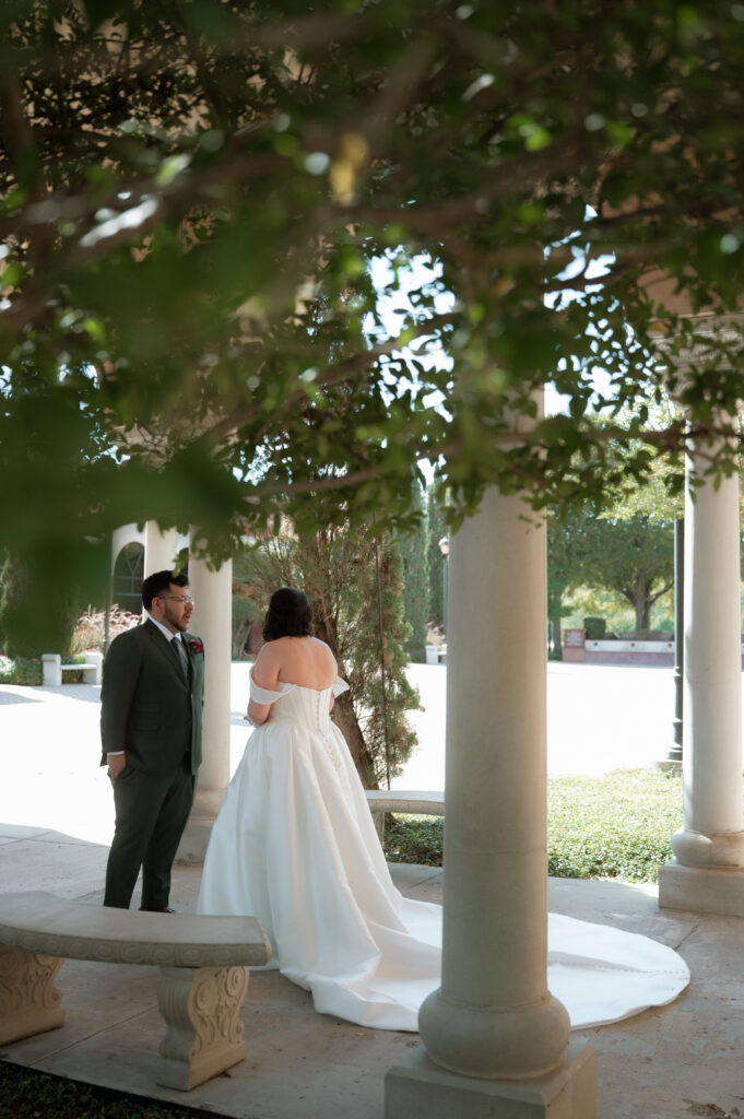 photo of bride and groom during their first look taken by Dallas wedding photographer
