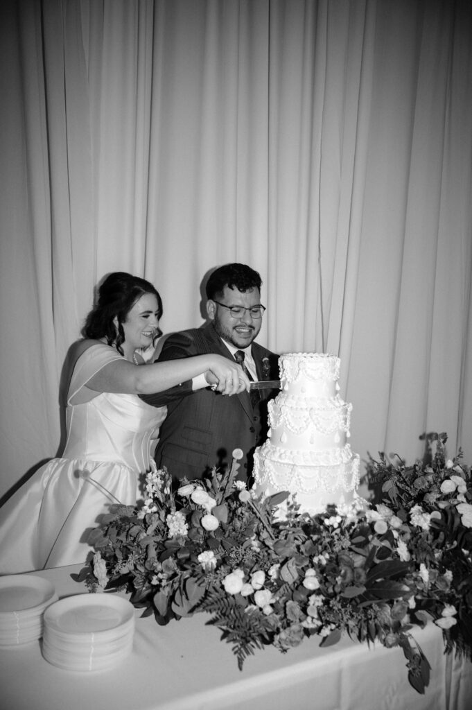 photo of bride and groom cutting cake